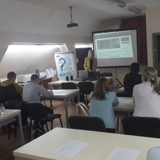 a classroom, teacher in front delivering her presentation