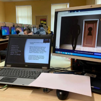 desk with a laptop and a monitor