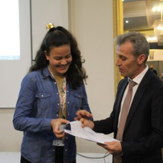 Rabia receiving a certificate