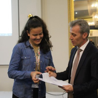 Rabia receiving a certificate